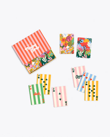 colorful playing card deck with multicolor floral design on back and assorted stripe pattern on front with coordinating striped packaging