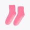 pink cozy socks with tonal "DOING NOTHING" text on sole