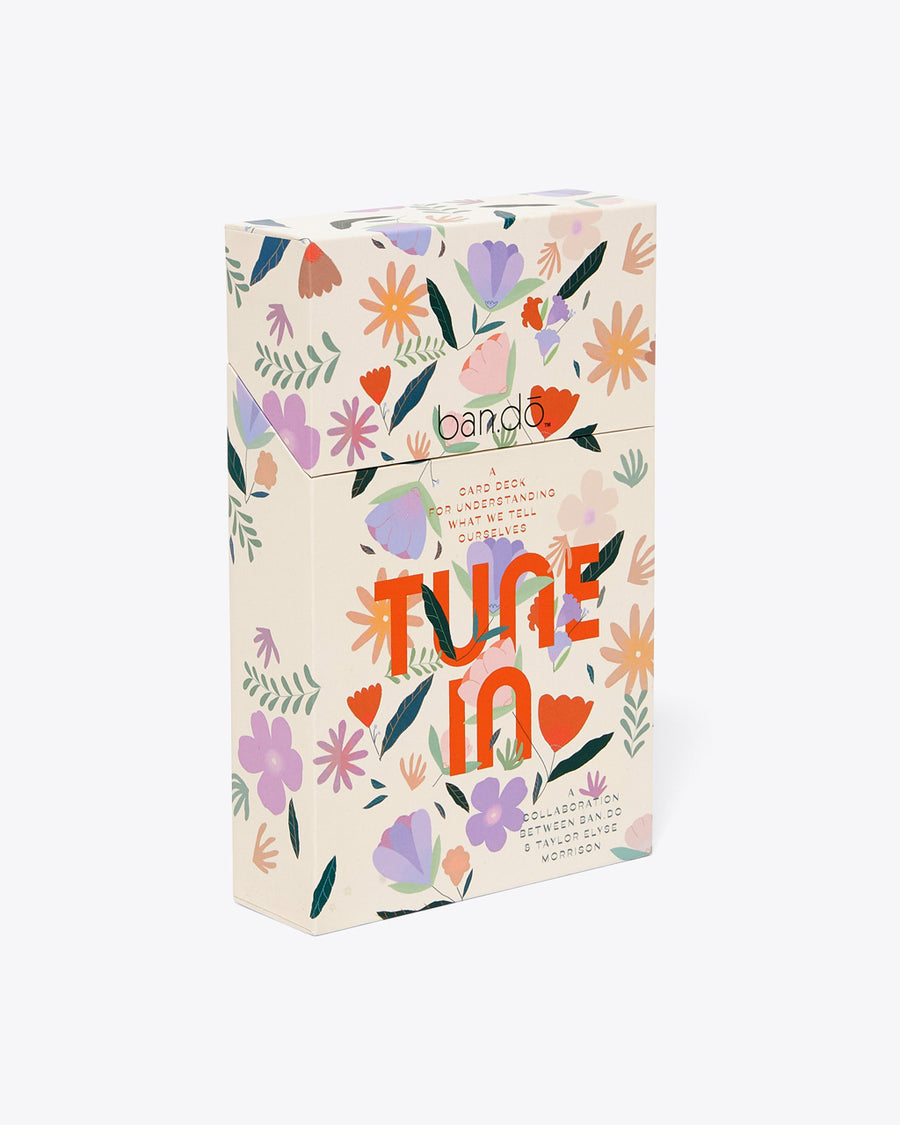 ivory card deck case with delicate floral pattern and "TUNE IN" text graphic on front