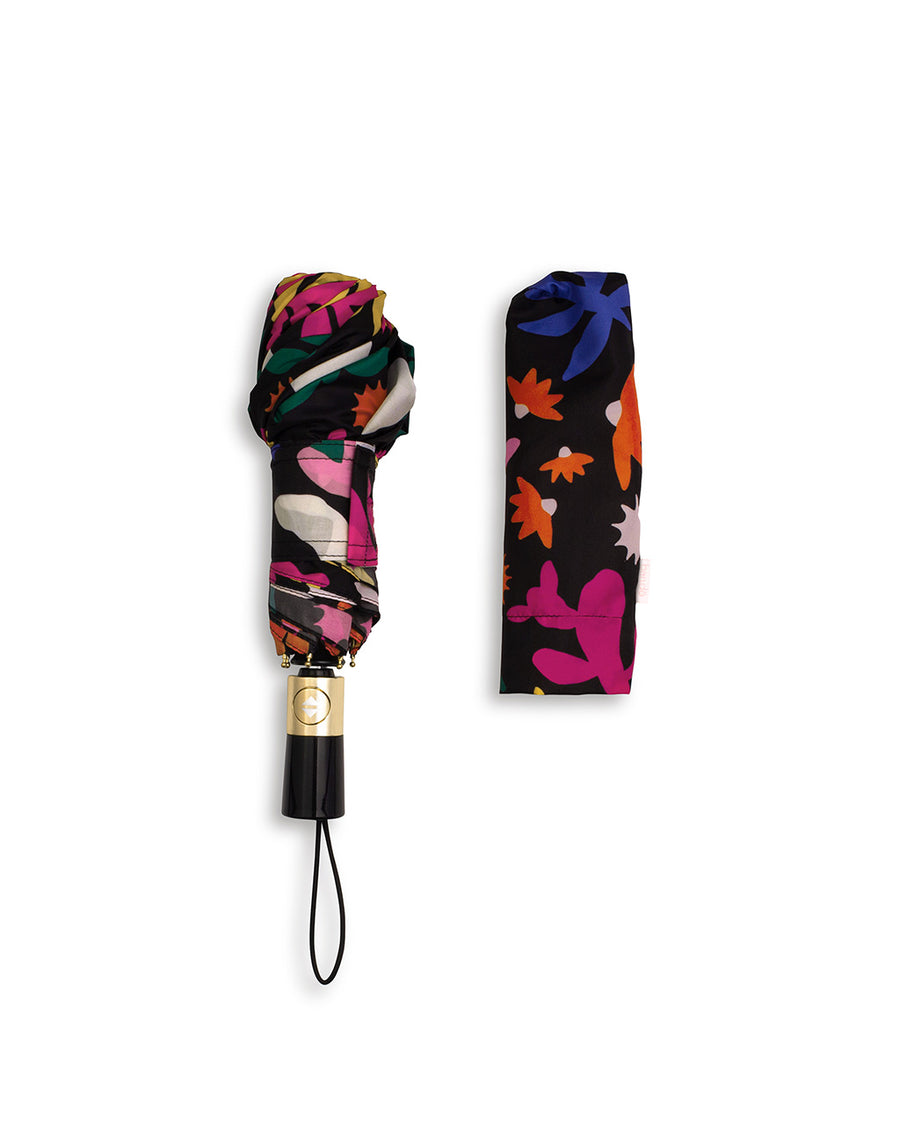 closed umbrella with black ground with multicolor abstract floral print with matching sleeve