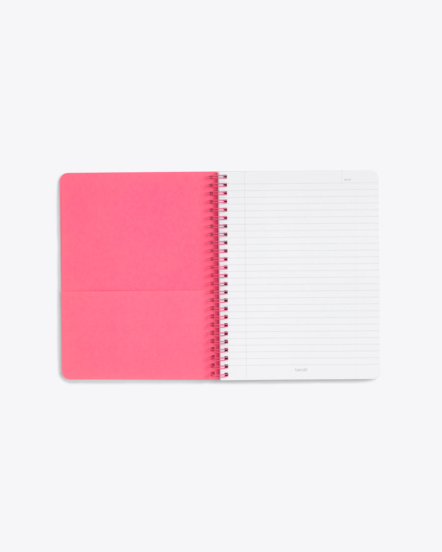 inside front cover of lined notebook showing pink pocket page and lined notebook page