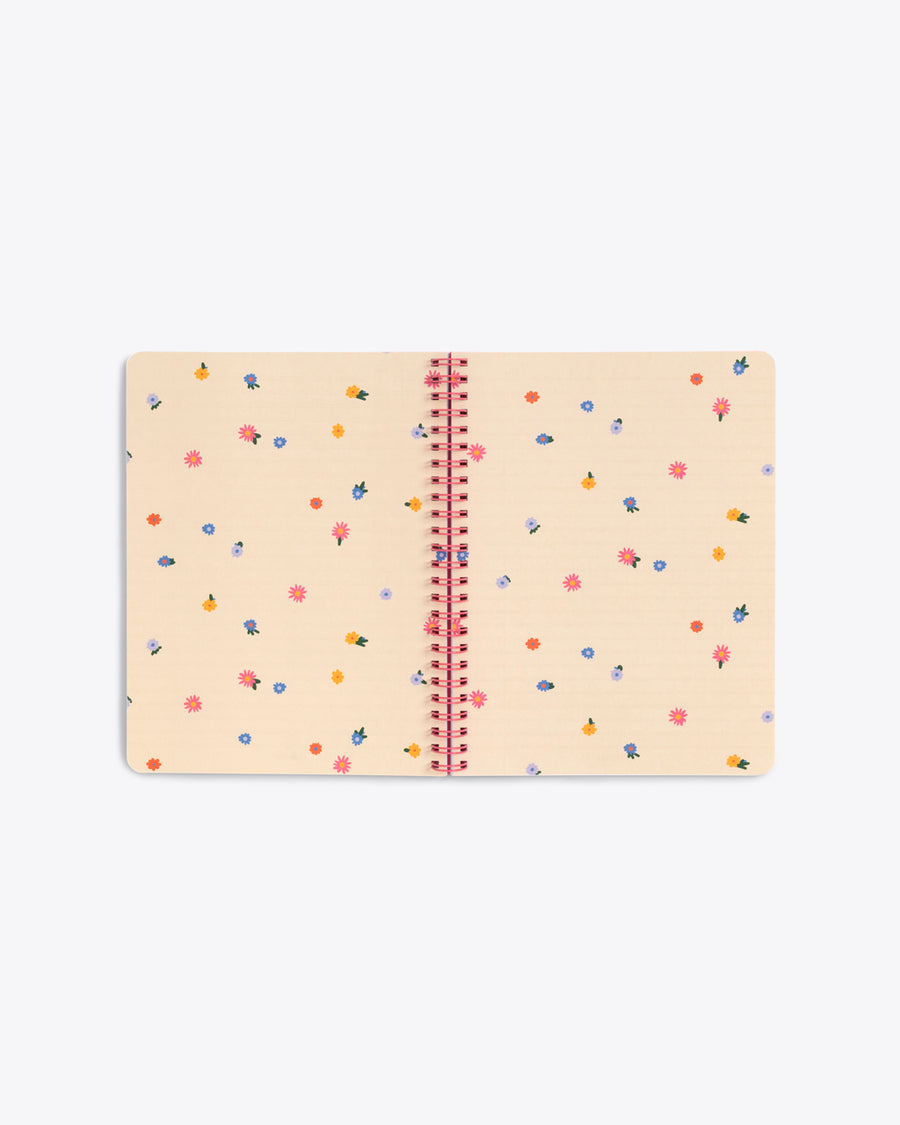 centerfold page of spiral bound notebook with ivory pages with tiny multicolor floral pattern