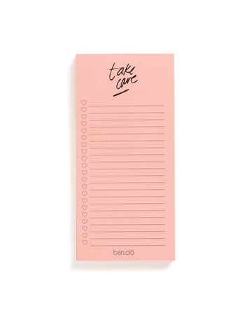 Pink rectangular notepad with "Take Care" printed at the top and horizontal lines with checkboxes printed below