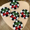 round rug mugs with black and white checker with red cherry design on a table