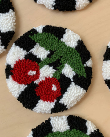 round rug mug with black and white checker with red cherry design